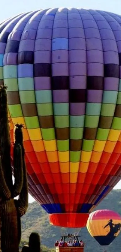 Colorful hot air balloons above desert cacti.