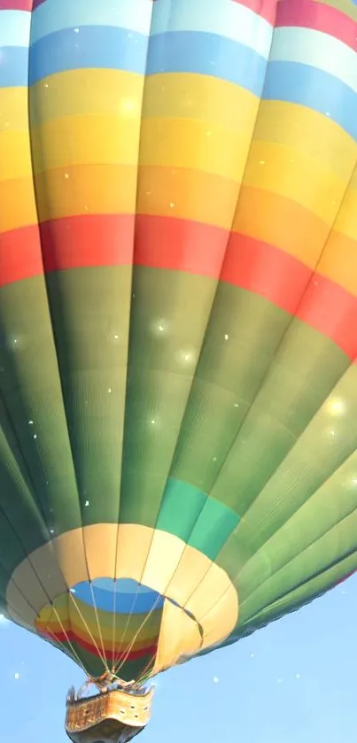 Colorful hot air balloon floating in blue sky.