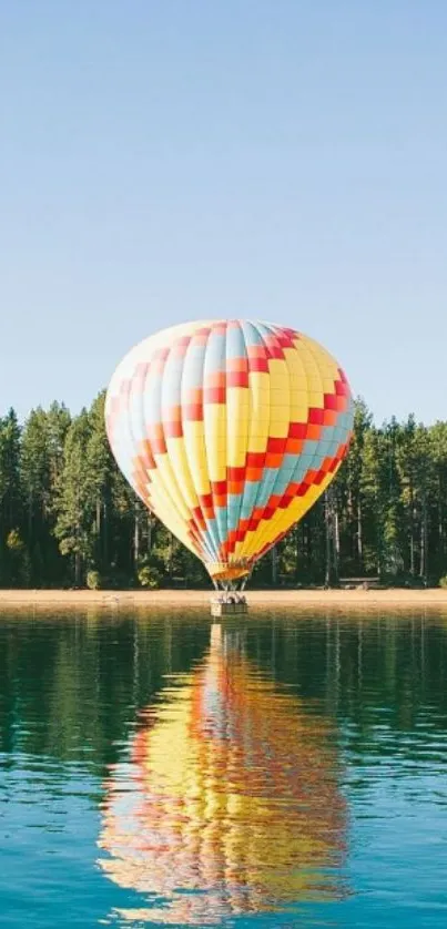 A colorful hot air balloon over a tranquil lake with blue sky.