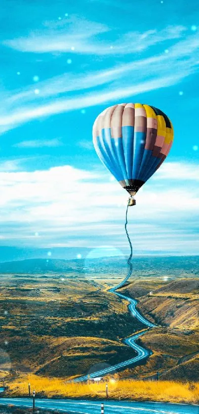 Colorful hot air balloon over scenic landscape with a blue sky.