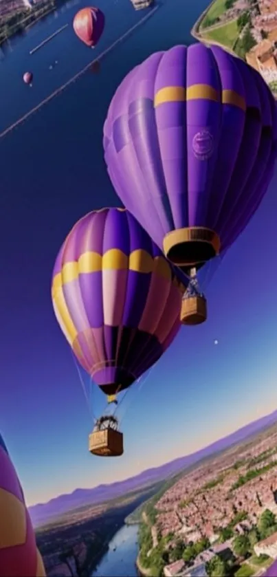 Purple hot air balloons over a riverside landscape at sunrise.