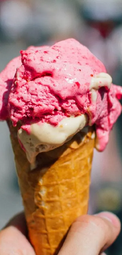 Picture of a pink ice cream cone in focus.