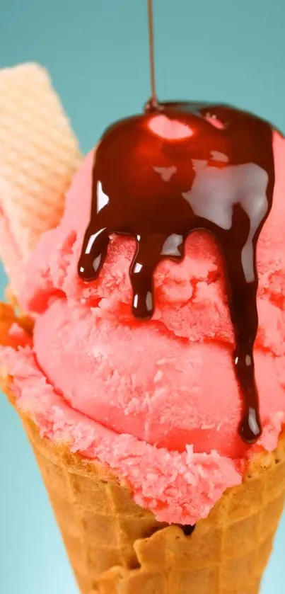 Pink ice cream cone with chocolate syrup on teal background.