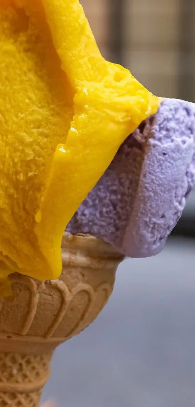 Yellow and purple ice cream scoops on a cone.