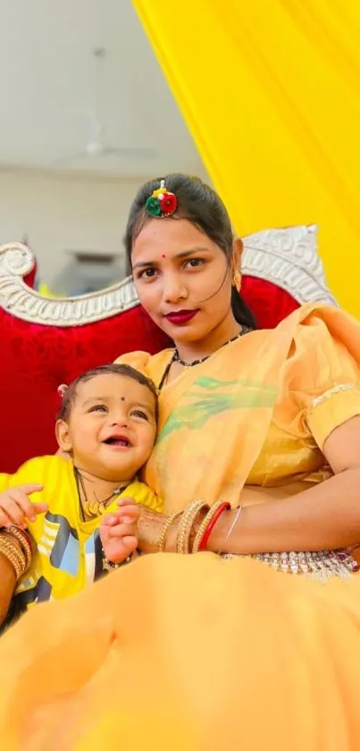 A vibrant portrait of an Indian woman and child dressed colorfully on a bright background.