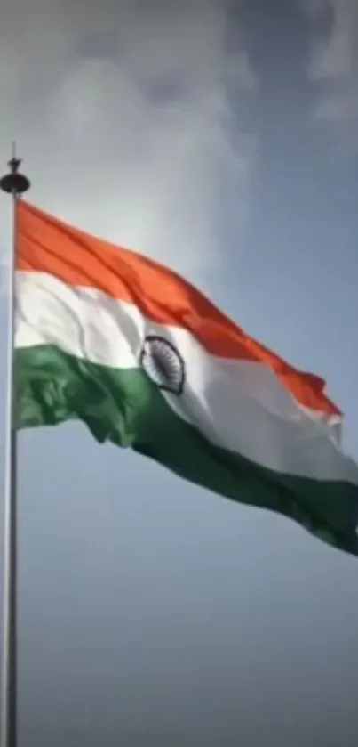 Indian flag waving proudly against a blue sky.