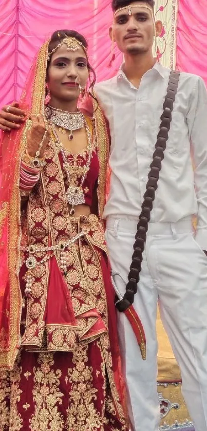 Colorful Indian wedding scene with traditional attire and pink drapes.