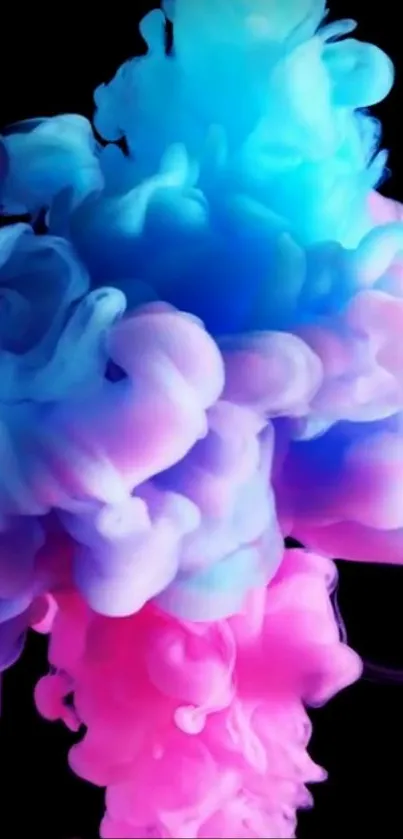 Vibrant blue and pink ink cloud on black background.