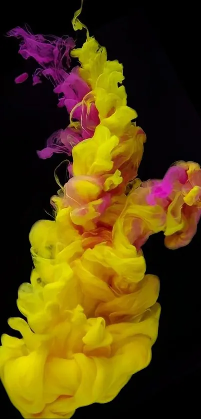 Vibrant yellow and pink ink swirling on black background.