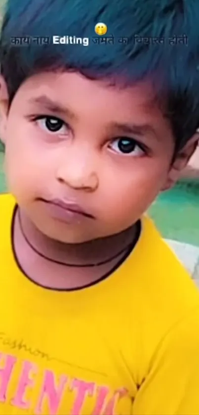 Cute child in a yellow shirt with a curious expression on a colorful background.