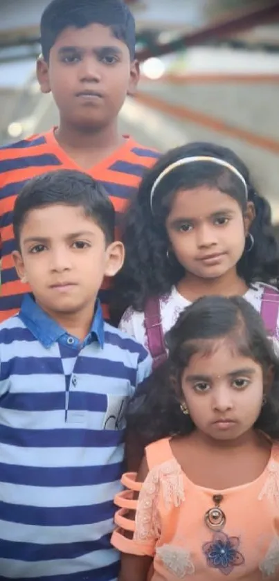 Group of children posing for a photo outside.