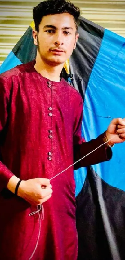 Person holding string of a colorful kite with traditional attire.