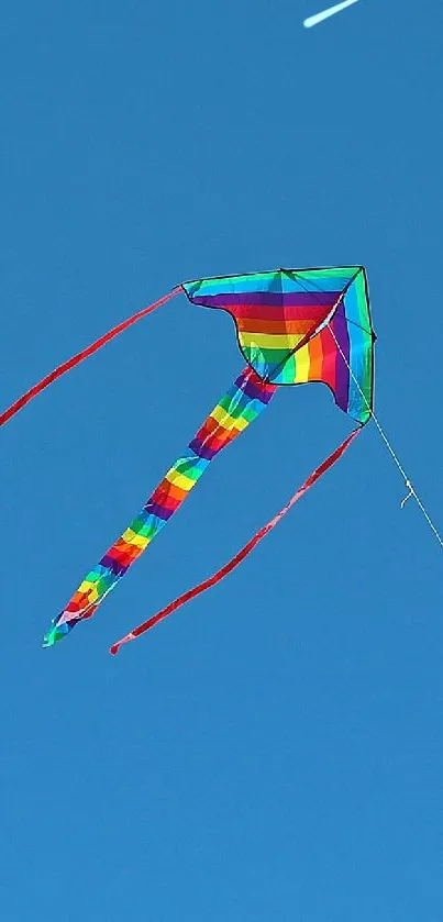 Colorful kite soaring in a clear blue sky.