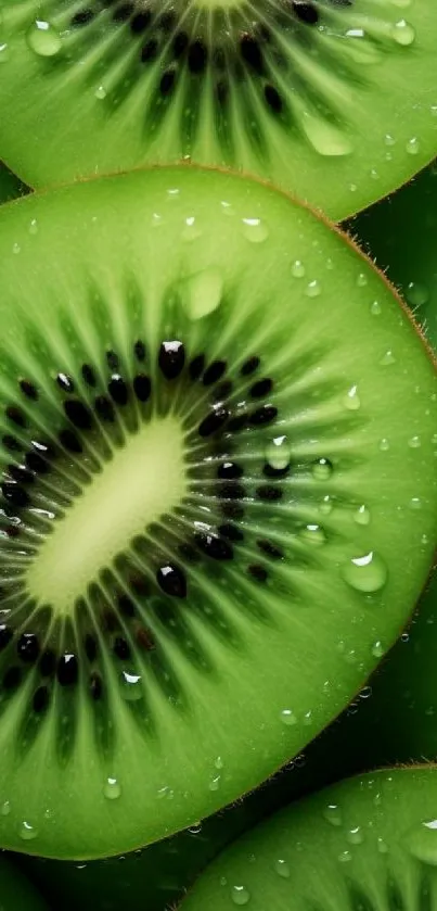 Bright green kiwi slice wallpaper with water droplets on a mobile screen.