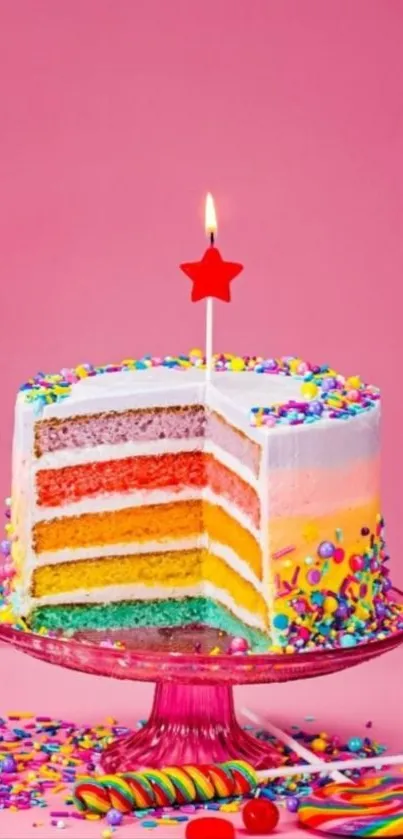 Multicolored layered cake with sprinkles and a star candle on a pink background.