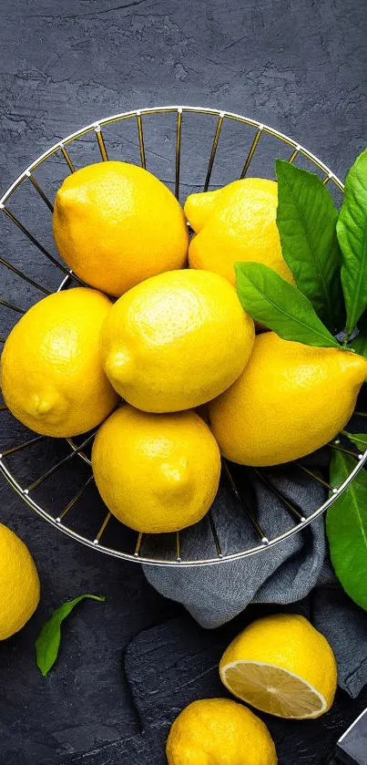 Basket of yellow lemons on a dark surface with green leaves and a knife.