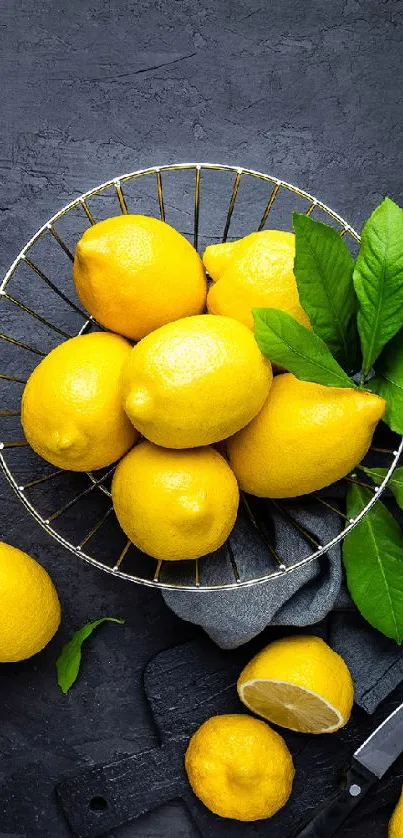 Bright yellow lemons on dark slate background.