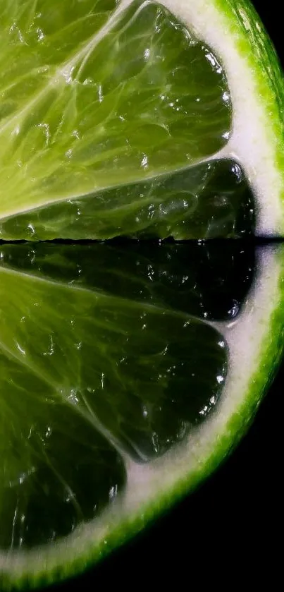 Close-up of a lime slice with mirror reflection in dark background.