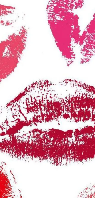 Vibrant pink and red lipstick kiss prints on a white background.