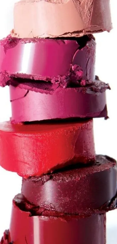 Vibrant red and pink lipstick stack displayed elegantly.