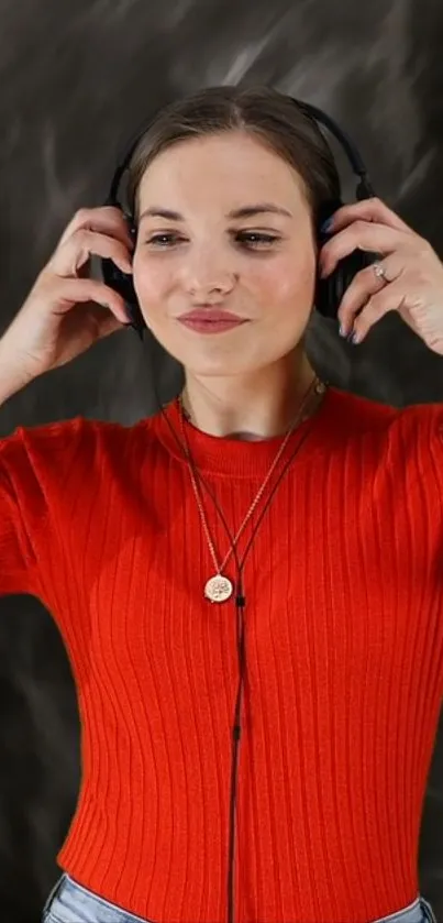 Woman in red shirt listening with headphones.