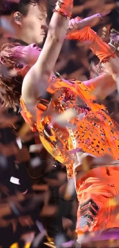 Dynamic performance with orange hues and confetti shower background.