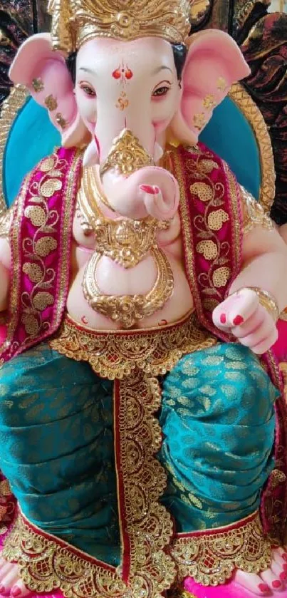 Vibrant Lord Ganesha statue in traditional attire, with pink and teal accents.