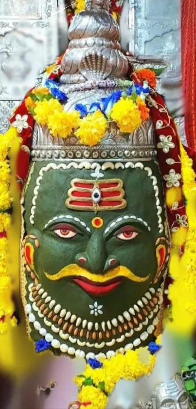 Brightly decorated Lord Shiva idol with flowers.