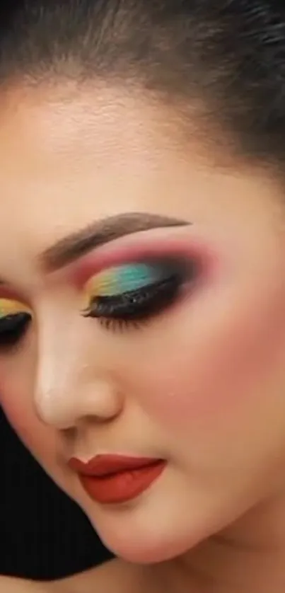 Vibrant makeup art on a serene face with colorful eye shadow against a black background.