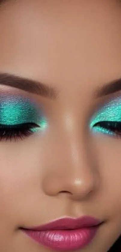 Close-up of vibrant makeup with teal eyeshadow and pink lips.