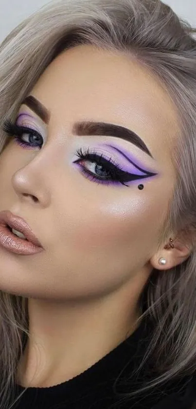 Mobile wallpaper with bold makeup and vibrant eyeliner design.