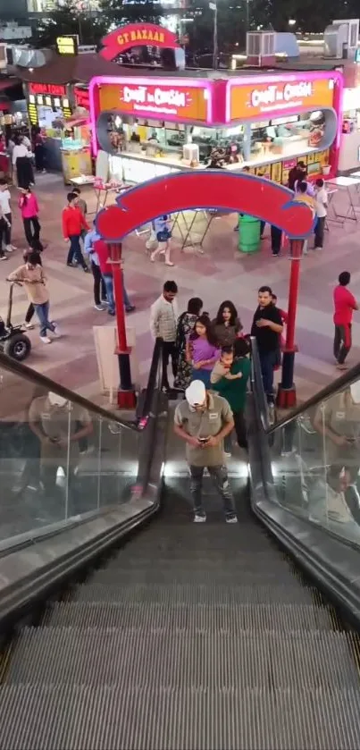 Busy mall escalator scene with vibrant colors and people.