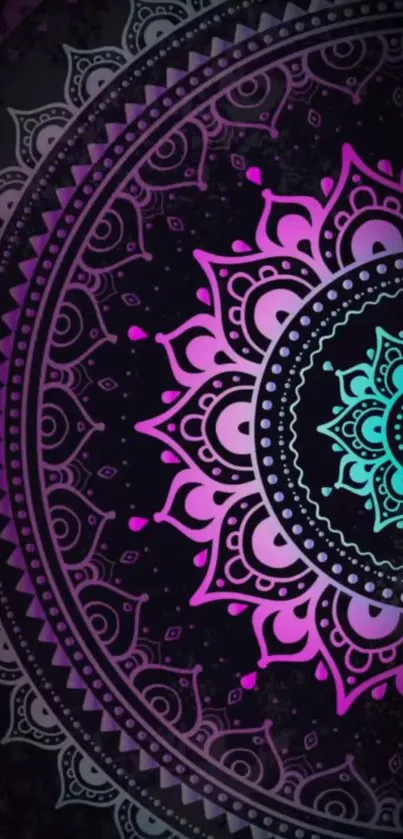 Vibrant mandala design in pink and teal hues on a dark background.