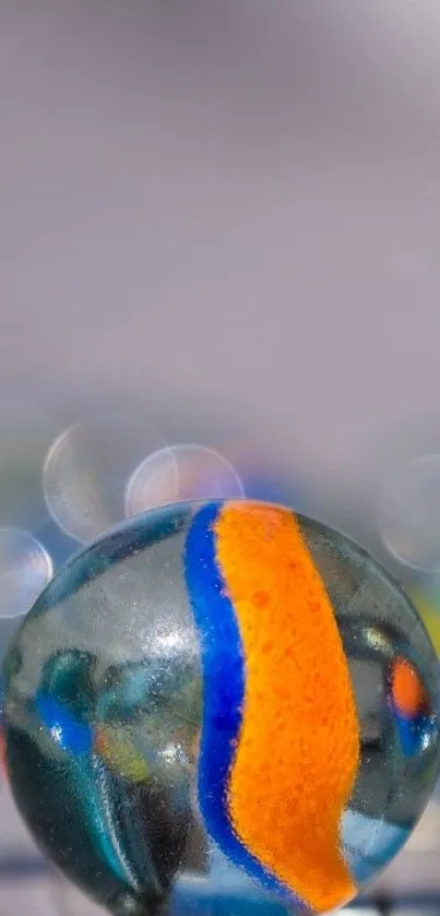 Close-up shot of vibrant orange and blue marbles with a bokeh background.