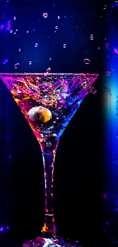 Vibrant martini glass with colorful splash on dark blue background.