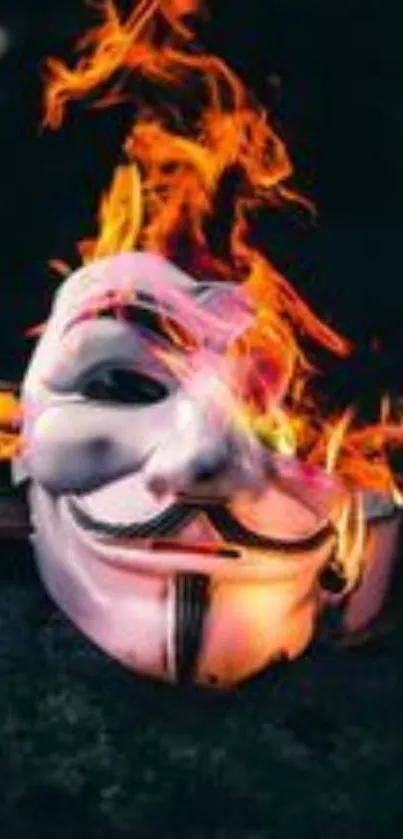 Artistic mask engulfed in fiery flames on a mobile wallpaper.