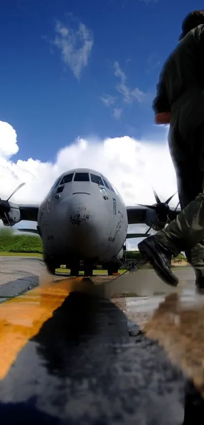 Military aircraft on runway with a soldier and vivid cloudy sky backdrop.