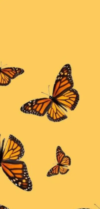 Yellow background with flying orange monarch butterflies.