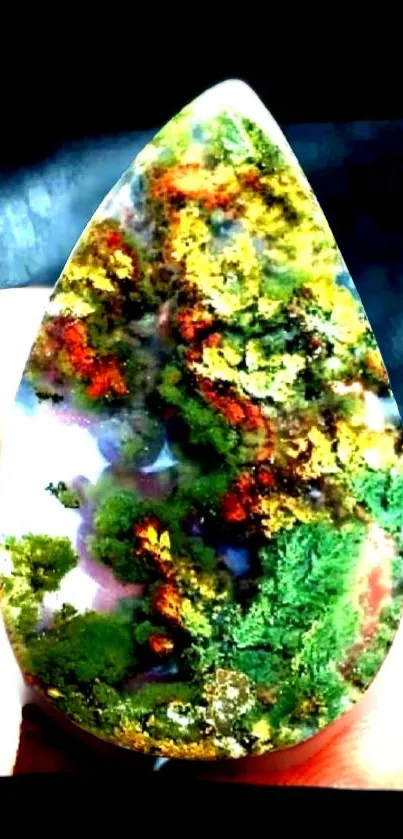 Vibrant moss agate gemstone with green, orange, and yellow patterns.