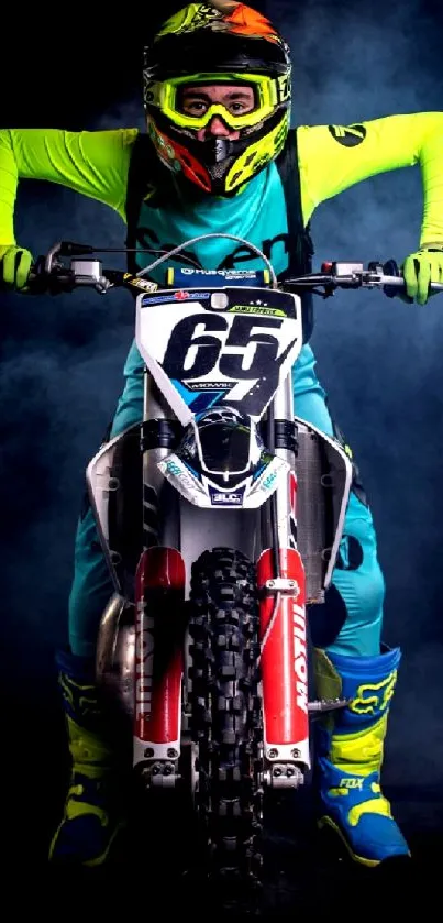 Motocross rider with neon gear and motorcycle in a smoky background.