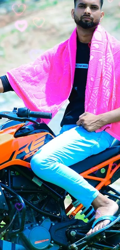 Man posing on an orange motorcycle against a lush green backdrop.