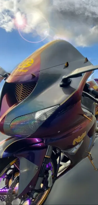 Vibrant sports motorcycle with a cloudy sky backdrop.