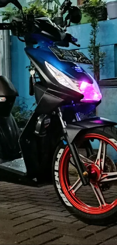 Blue motorcycle with neon lighting in an urban street setting at night.