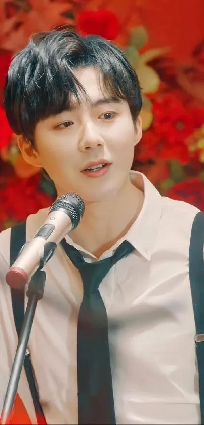 Musician in floral setting with microphone.