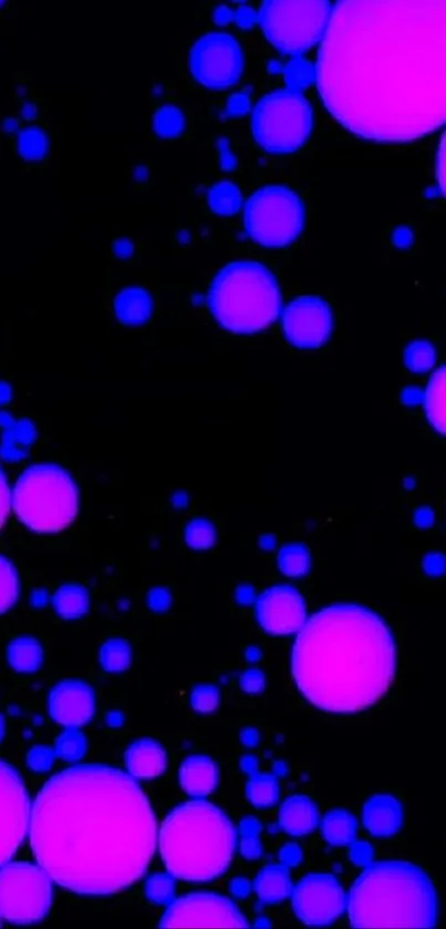 Colorful neon bubble wallpaper with pink and blue bubbles over a black background.