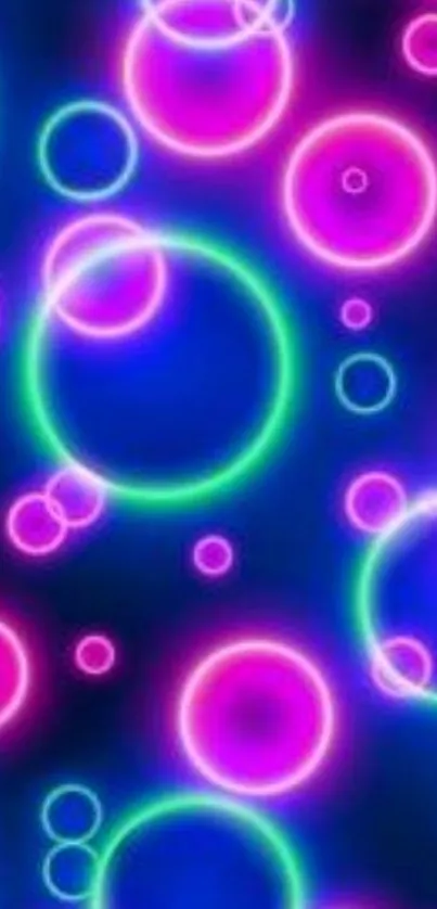 Vibrant neon circles glowing in pink, blue, and green on a dark background.