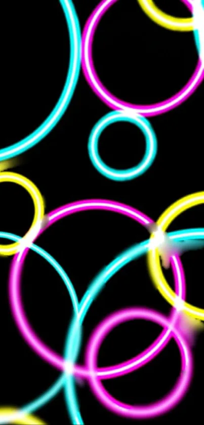 Vibrant neon circles in pink, blue, and yellow on a black background.