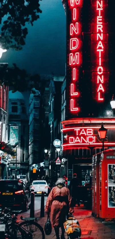 Nighttime city street with neon signs glowing.