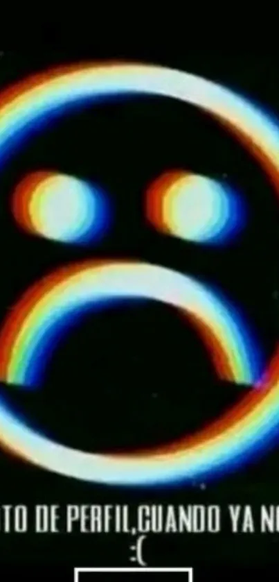 A neon emoticon with a sad face on a black background.