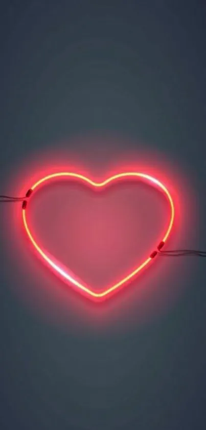 Neon heart with vibrant pink glow on dark background.